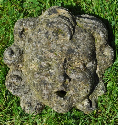 Lot 1200 - A small carved stone cherub fountain mask