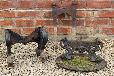 Lot 1332 - A group of three various old cast iron boot scrapers