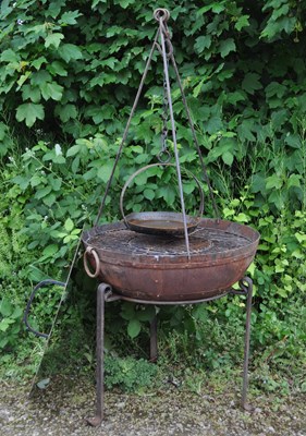 Lot 1213 - A wrought iron bowl shaped barbecue and fire pit