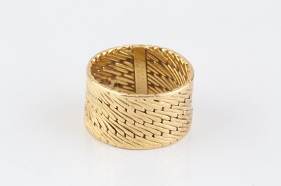 Lot 253 - A dress ring by Hermès, the wide band of...