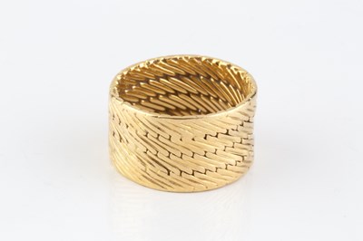Lot 253 - A dress ring by Hermès, the wide band of...
