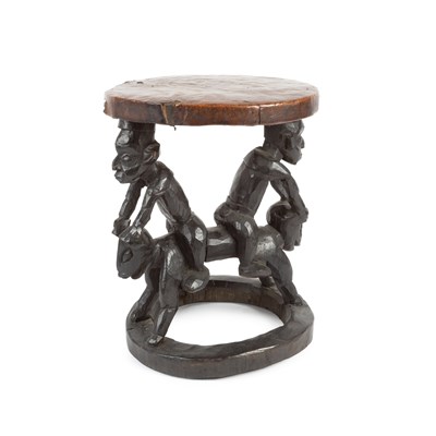 Lot 1027 - An African carved wooden tribal style stool