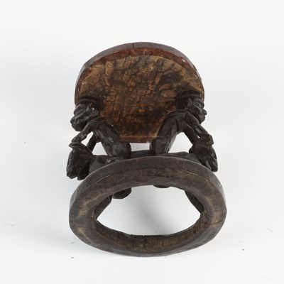 Lot 1027 - An African carved wooden tribal style stool