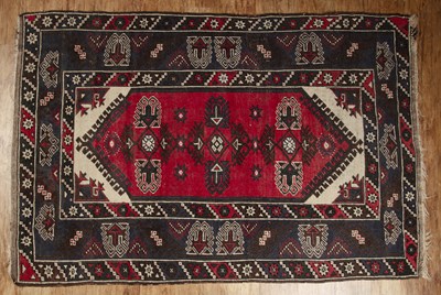 Lot 54 - Red ground rug with geometric pattern border...