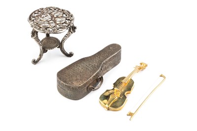 Lot 538 - A silver-gilt miniature model of a violin and...