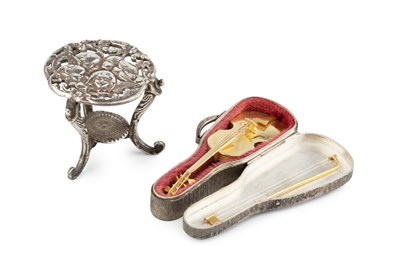 Lot 538 - A silver-gilt miniature model of a violin and...