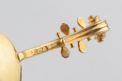 Lot 538 - A silver-gilt miniature model of a violin and...
