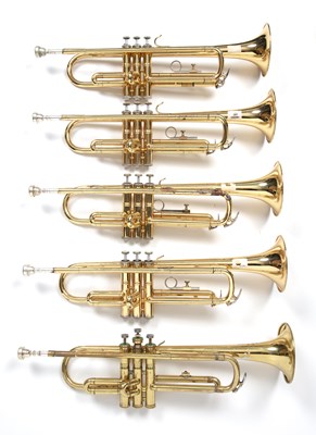 Lot 141 - A 'Melody Maker' brass trumpet; and four...