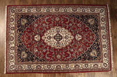 Lot 29 - Polychrome knotted rug burnt cerulean ground,...