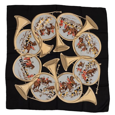 Lot 582 - A Hermès silk scarf depicting interlocking...