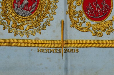 Lot 584 - A ‘Les Armes de Paris’ silk scarf by Hermès,...