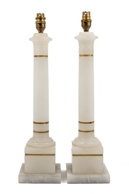 Lot 692 - A pair of alabaster table lamps