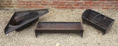 Lot 1435 - A group of three various old cast iron feeding troughs