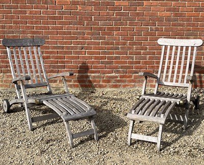 Lot 1391 - A pair of teak steamer chairs