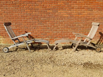 Lot 1391 - A pair of teak steamer chairs