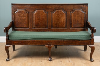 Lot 668 - A George III oak settle