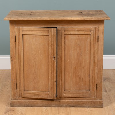 Lot 497 - A small pine two-door kitchen cupboard