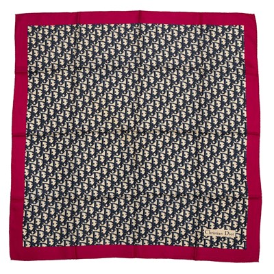 Lot 558 - A Christian Dior silk scarf featuring the logo...