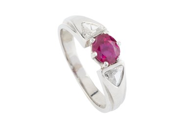 Lot 110 - A ruby and diamond three stone ring, the oval...