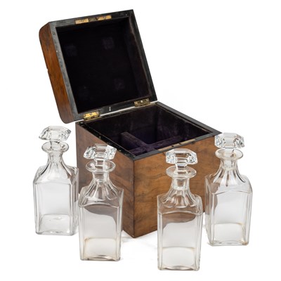 Lot 77 - A set of four cut glass decanters in a walnut box with a spare stopper.