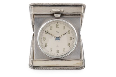 Lot 707 - A silver travelling timepiece, the engine...