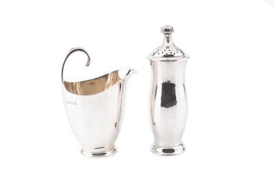 Lot A planished silver cream jug, with simple...