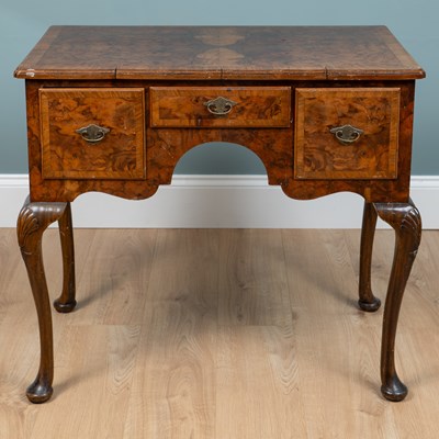 Lot 690 - A Georgian style walnut lowboy