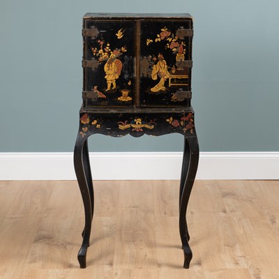 Lot 1177 - An antique Oriental black lacquered chinoiserie decorated cabinet on stand