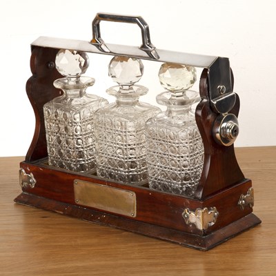 Lot 209 - Late Victorian walnut Tantalus with silver...