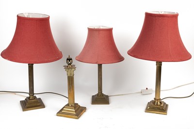 Lot 374 - Four antique brass table lamps