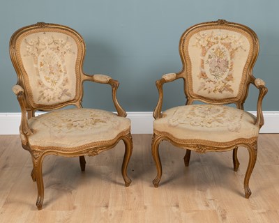 Lot 133 - A pair of Louis XV French gilt-framed elbow chairs