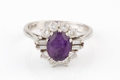 Lot 287 - An amethyst and diamond cluster ring, the oval...
