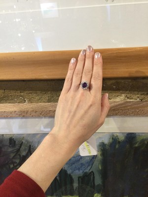 Lot 287 - An amethyst and diamond cluster ring, the oval...