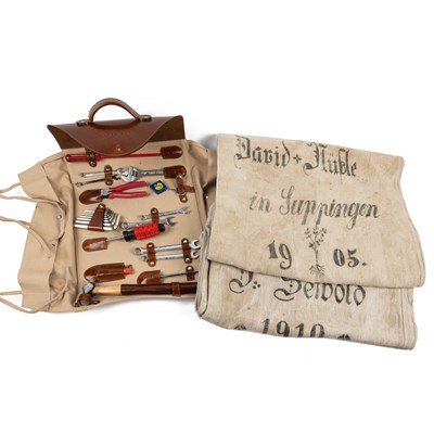 Lot 551 - A tool roll together with two early 20th-century flour sacks