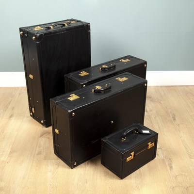 Lot 1027 - A suite of four black leather Asprey suitcases