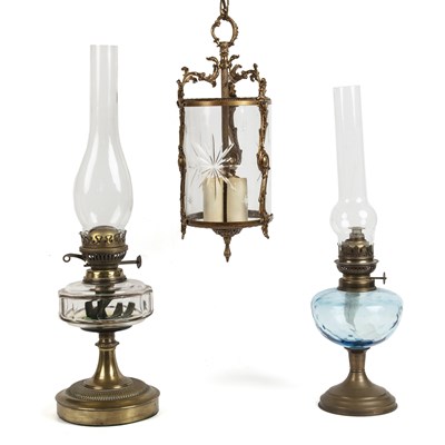 Lot 252 - A brass hanging lantern together with two glass and brass oil lamps