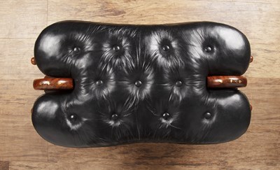 Lot 56 - Camel saddle stool 20th Century, with black...