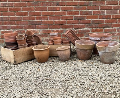 Lot 1398 - A collection of terracotta flower pots and a trough