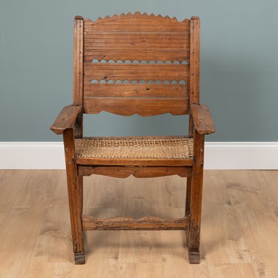 Lot 1074 - A composed rustic armchair