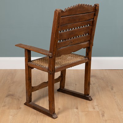 Lot 1074 - A composed rustic armchair