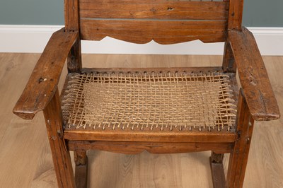 Lot 1074 - A composed rustic armchair
