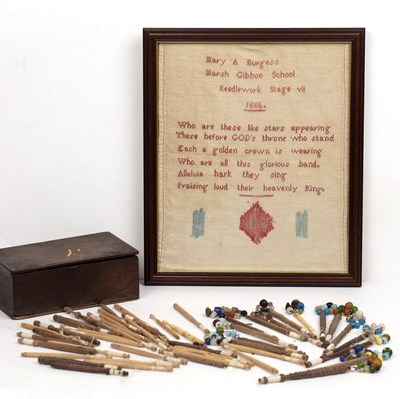 Lot 414 - A Victorian sampler and a collection of lace bobbins