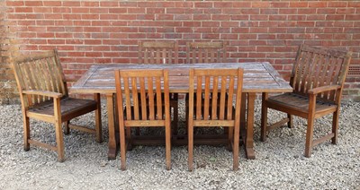 Lot 1484 - A teak garden table with six chairs