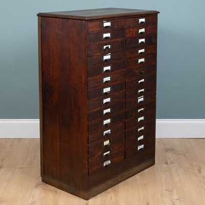 Lot 569 - An early 20th century oak filing cabinet with brass mounts