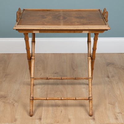 Lot 1075 - An early 20th century olivewood butler's tray on a folding stand