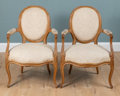 Lot 18 - A pair of French Louis XVI style beechwood open armchairs