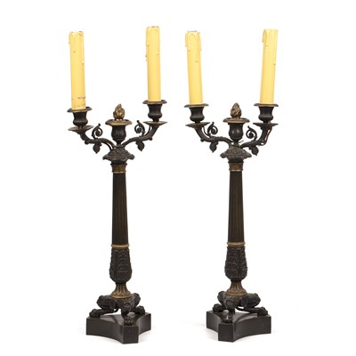 Lot 127 - A pair of early 19th century French bronze twin-branch candelabra