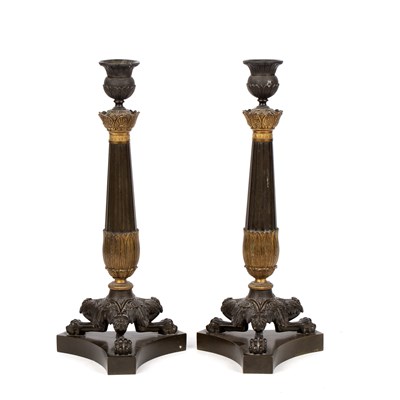 Lot 718 - A pair of mid-19th century French Empire bronze candlesticks