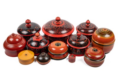 Lot 581 - A group of twelve turned painted Indian spice boxes