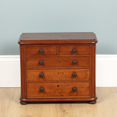 Lot 582 - A miniature chest of drawers